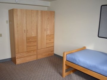 Bedroom of Montgomery Place Apartments showing two closets and bed
