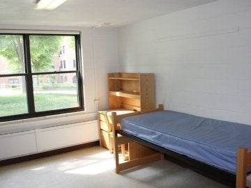 Bedroom of Northumberland Hall showing bed, desk with chair and window