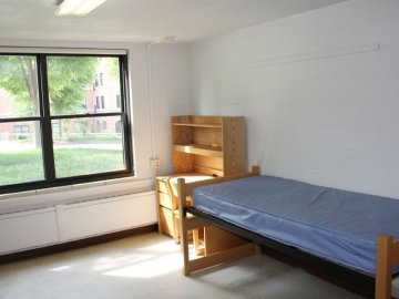 Bedroom of Northumberland Hall showing bed, desk with chair and window