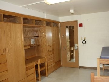 Bedroom for Schuylkill Hall showing built in closets and desks, beds and the door