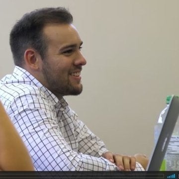 Hunter Emenheizer smiling in front of a computer