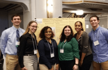 A group of people standing side by side. 