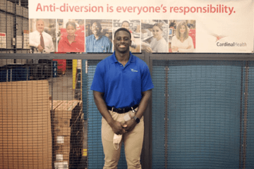 A guy standing in front of a wall. 