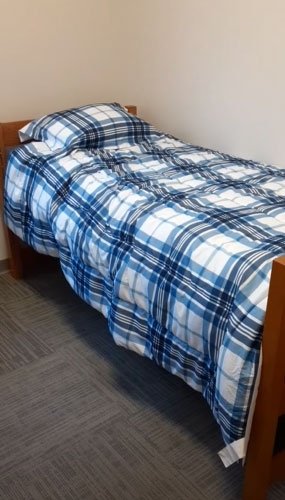 Bed in Fairview Suites private bedroom at CU-Lock Haven