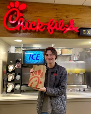 Student holding up bag of Chick-fil-A at Commonwealth University - Lock Haven