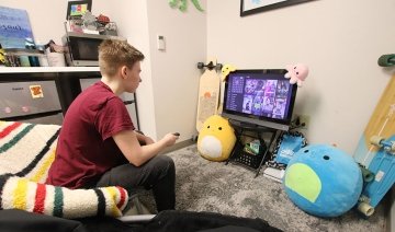 Student watching TV in Fairview Suites at Commonwealth University - Lock Haven
