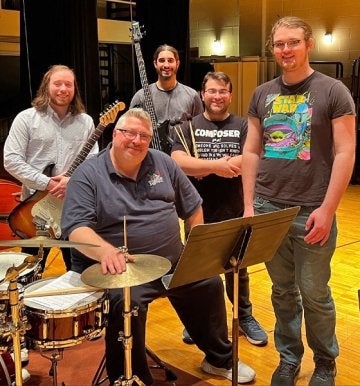 Music students and professor pose for photo with instruments at CU-Mansfield