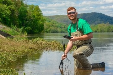 Environmental Science student doing research at a river