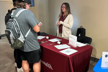A recruiter for First Commonwealth Bank speaks with two students at a recent Career Connections Expo