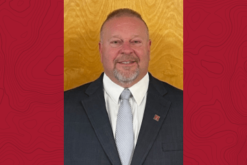 headshot of Rod Pusell on red background