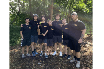 Phi Mu Delta brothers with trophy