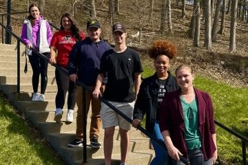 A group of students standing on a staircase. 