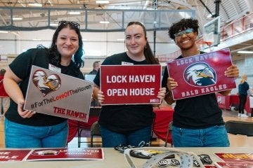 Students hold signs at a Commonwealth University - Lock Haven Admissions Open House