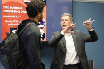 Presenter speaking with a student at the 2025 ZIPD Conference at CU-Lock Haven
