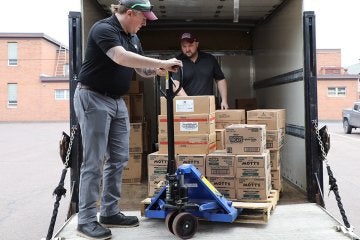 John Scheers and Josh Jensen of Aramark unload food at the Bloomsburg Food Bank.