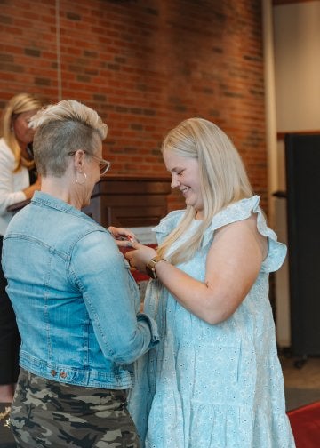 CU-Mansfield student receives her pin during the teacher induction and pinning ceremony.