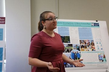 Female student discusses Microplastics poster at FDI Poster Session