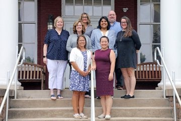 Alumni and Profession Engagement team on Carver Hall steps.