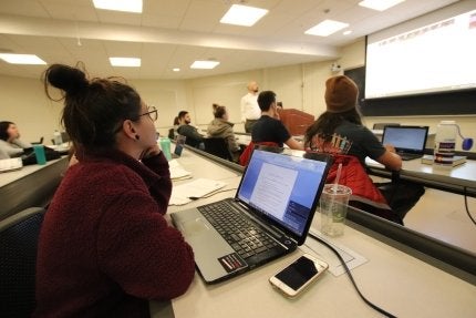 Sociology students in class, listening to a lecture.