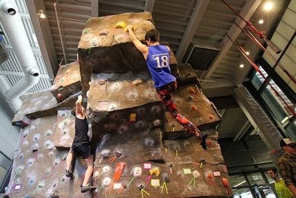 Quest students rock climbing indoors.