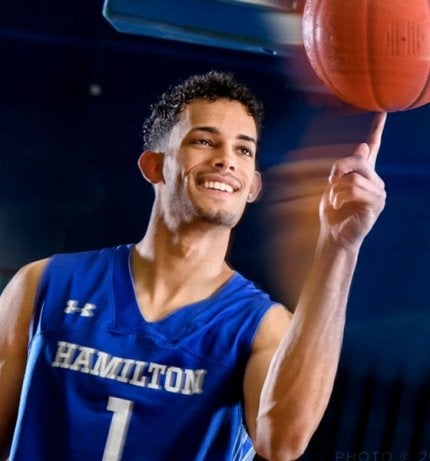 Kena Gilmour spinning basketball on his finger.