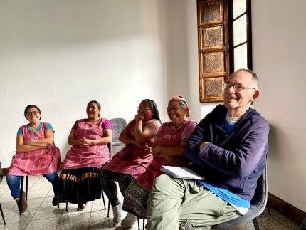 Dr. Steven Granich leading a stress management group with kitchen staff at Education and Hope