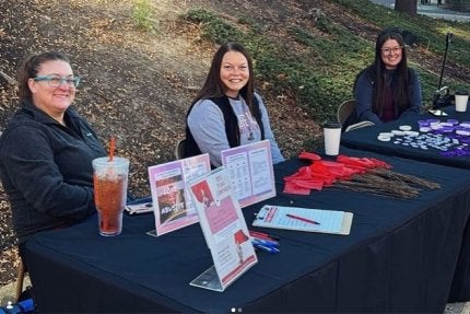 Three CEA members tabling for the Red Flag Campaign