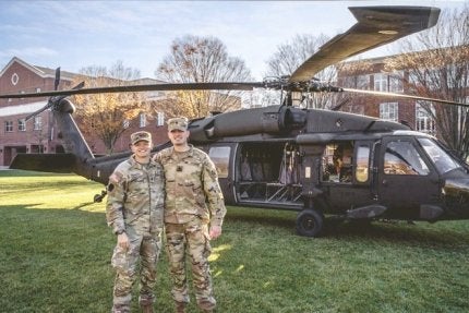 Army soldiers pose for photo with Blackhawk Helicopter on the Bloomsburg Campus
