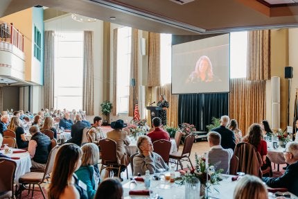 LHUF executive director, Ashley Koser, addresses donors and students at the James C. Reeser Scholarship Brunch