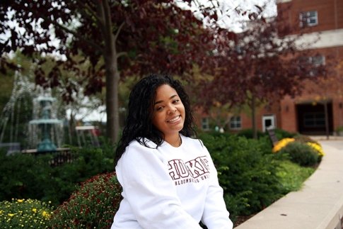 Caroline Trinidad '22 posing outside, smiling.