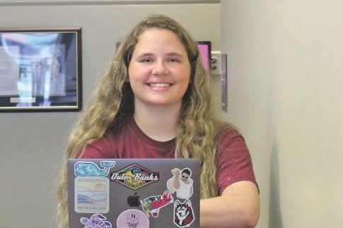 bloomsburg students behind a laptop looks forward