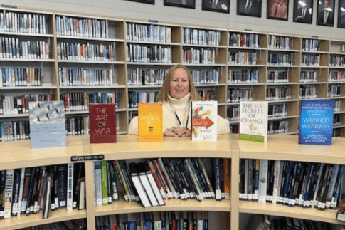 MEd Educational Leadership student in a library