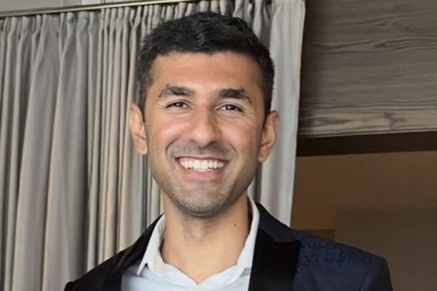 Keval Mandalia '24 in formalwear, smiling at the camera.