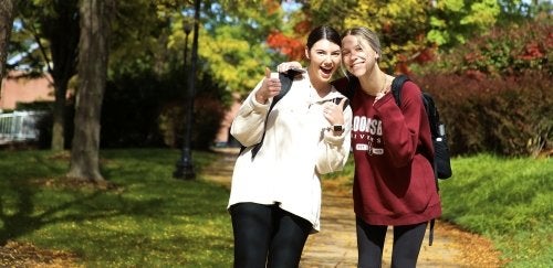 Two female Bloomsburg students giving thumbs up