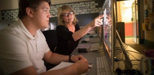 Student and professor working on various pieces through the digital art studio concentration