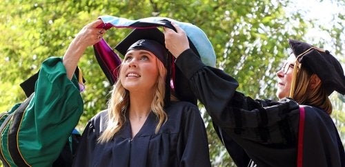 Female college graduate hooding