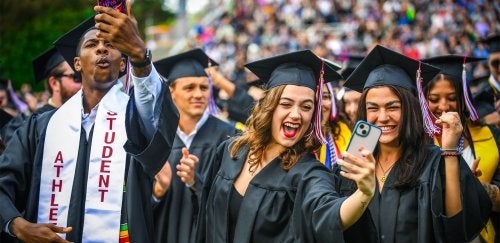 Students celebrate by taking selfies after graduating from Commonwealth University - Lock Haven