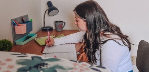 Commonwealth University student studies at desk on campus
