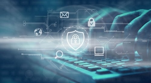 Person typing on keyboard with cyber security icon overlay