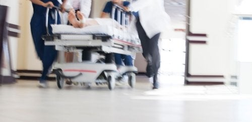 ER doctors pushing gurney