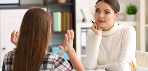Woman talks with patient in office setting.
