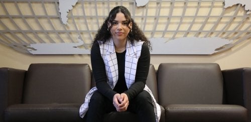 Bloomsburg student, Alice Obando-Salinas sitting on a couch.