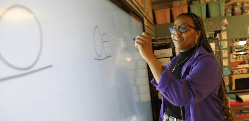 Education student writing on a whiteboard