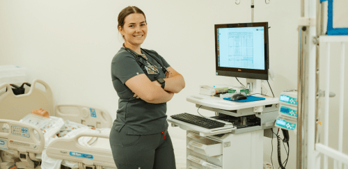 MSN Nurse Practitioner student standing at a computer