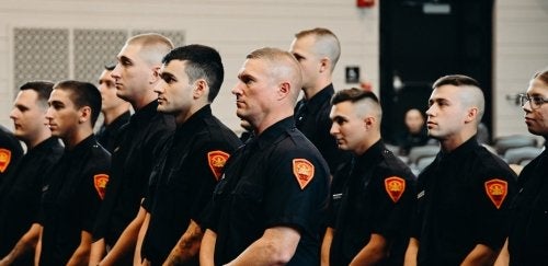 cadets at Commonwealth University-Mansfield's (formerly Mansfield University) Act 120 Municipal Police Academy stand at attention during their on campus graduation ceremony