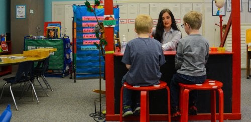 A teacher educating two grade schoolers