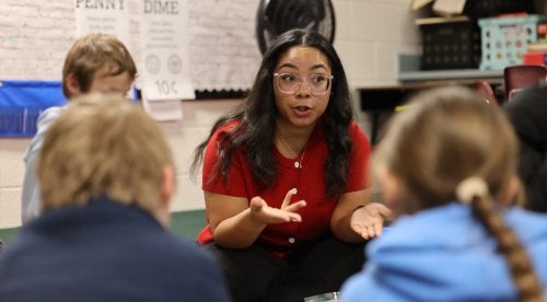 Student teacher, Anijah Lucena, sits down and talks with students