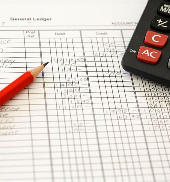 General ledger sheet with a pencil and calculator