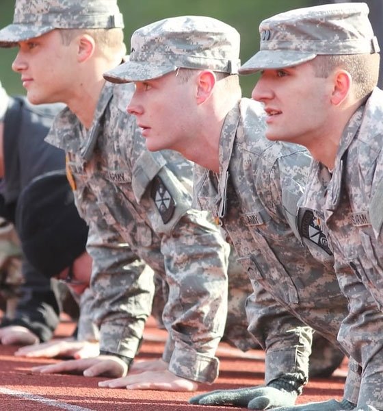 Military personnel doing pushups.