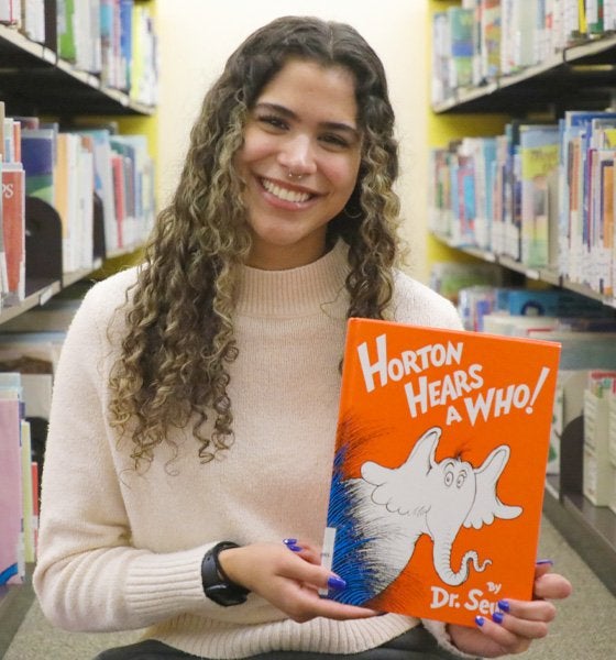 Student teacher, Kiahna Jones, hold the book 'Horton Hears a Who!'